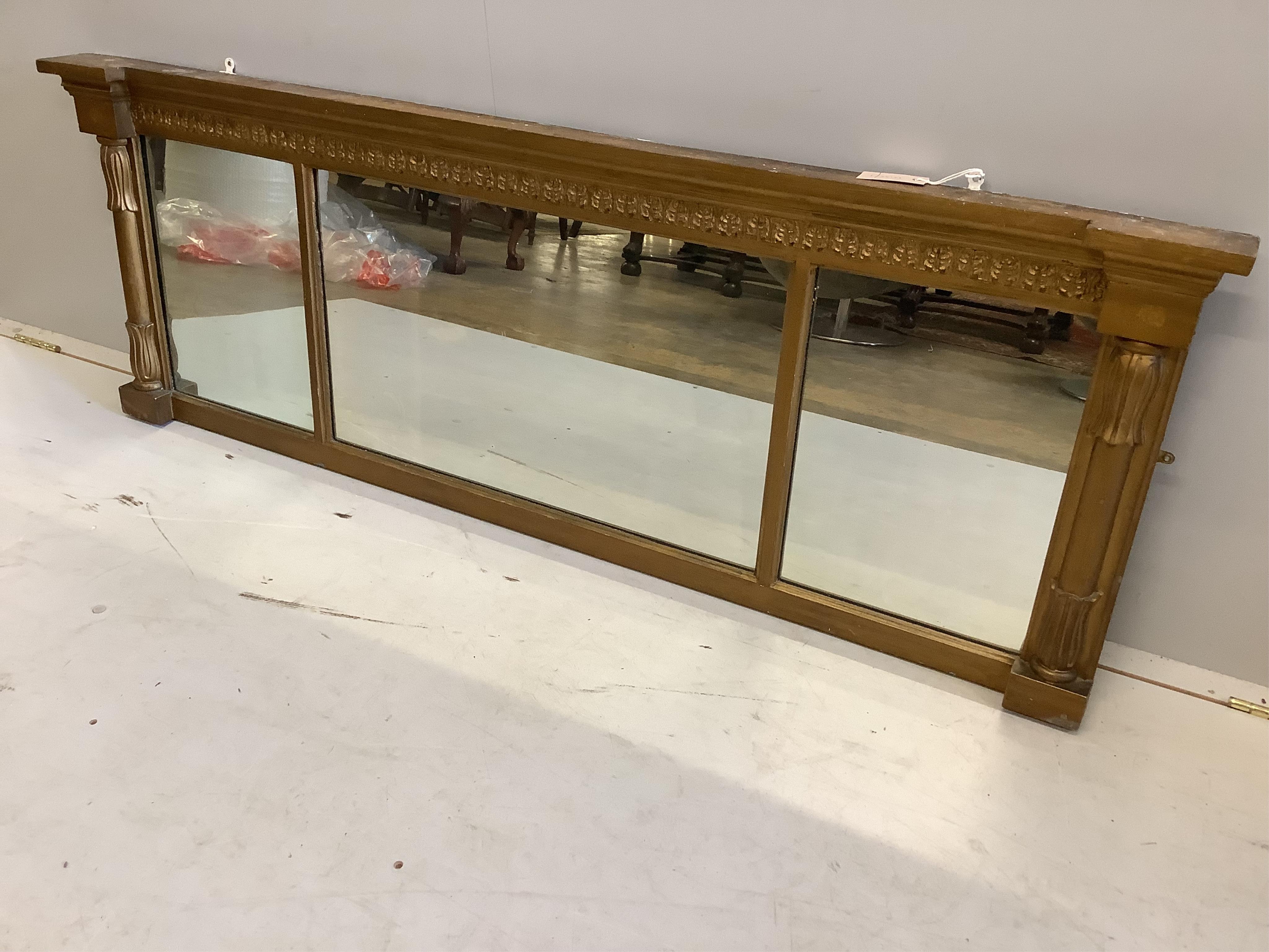 A William IV giltwood and composition triple plate overmantel mirror, width 155cm, height 54cm. Condition - fair